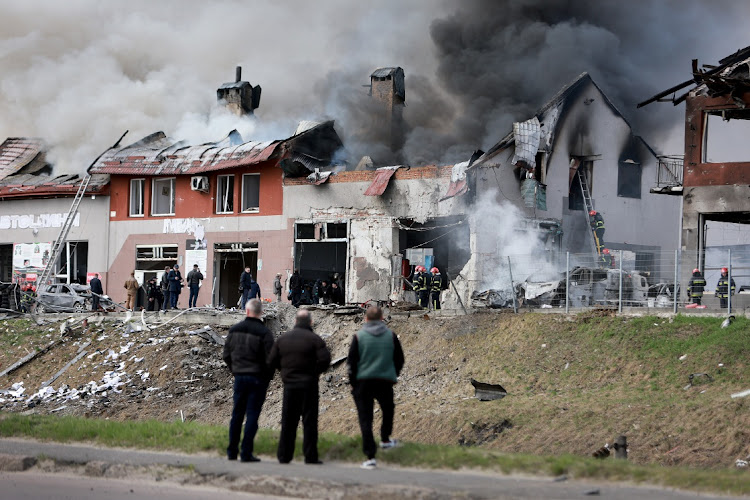 Firefighters battle a blaze after a civilian building was hit by a Russian missile on April 18, 2022 in Lviv, Ukraine.