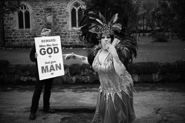 A lone anti gay demonstrator standing in front of a church, is mocked by Betty Bangles, during a pride parade through the small town of Knysna. Thousands attended the parade, which was a culmination of The Pink Loerie Mardi Gras & Arts Festival Knynsa,is billed as 'an annual celebration of lesbian, gay, bisexual, transgender and intersex (LGBTI) culture and identity and is proudly hosted in the picturesque town of Knysna."