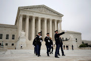 Police officers walk on the plaza of the Supreme Court in Washington US