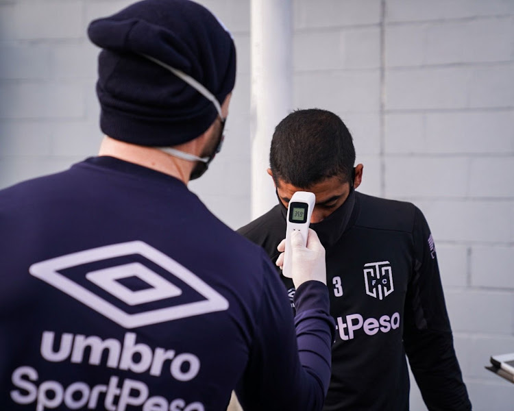 Ebrahim Seedat of Cape Town City is put through the Covid-19 safety measure protocols upon arrival for training at the club's Hartleyvale training center in Cape Town.