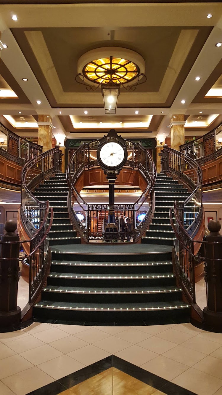 The Queens Arcade on deck 3 of Queen Victoria, inspired by the Royal and Burlington Arcades in London, features a grand staircase.