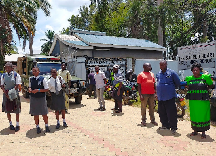 Students and parents outside the school gate of Mukumu Girls.