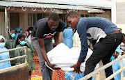 Relatives load the body of a one-year-old child who died at a health centre dealing with water borne diseases onto a truck in Beira on Wednesday.