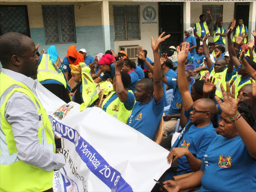 Paul Adhuch, director of anti-human trafficking NGO Trace Kenya, addresses Mombasa residents during the World Day Against Trafficking in Persons on Tuesday/JOHN CHESOLI