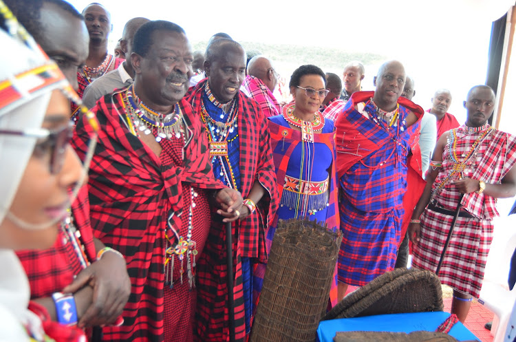 Prime Cabinet Secretary Musalia Mudavadi with Kajiado Governor Joseph ole Lenku, Narok women representative Rebecca Tonkei and Kenya National Chamber of Commerce and Industry South Rift region national director David Mpatiany during Maa cultural week at Sekenani area in Narok county on Wednesday. PHOTO/KIPLANGAT KIRUI