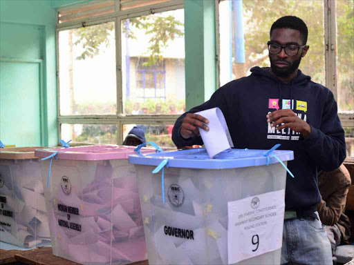 A voter casts their ballot at Highway Secondary School during the August 8 general election. /FILE