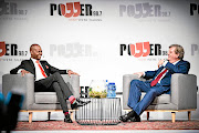 The writer says  it's absurd to suggest that billionaire   Johann Rupert, above with Given Mkhari,  was out to insult black people on  'Chairman's Conversation' on Power FM on Tuesday night.