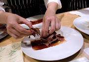 A dish of beef tongue with cherry miso, fried quinoa and palm seeds dish is prepared at WD-50, a restaurant located at 50 Clinton Street in New York, U.S., on Wednesday, July 9, 2008. New York's Clinton Street neighborhood is a hybrid of the gritty and the gentrified, with bodegas and aging beauty salons interspersed with hip clothing boutiques and a yoga studio.