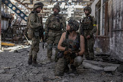 Ukrainian service members speak to each other in the industrial area of the city of Sievierodonetsk, as Russia's attack on Ukraine continues, Ukraine June 20, 2022.  