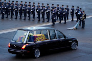 The coffin of Queen Elizabeth II is transported in the royal hearse from an RAF aircraft to Buckingham Palace in London.