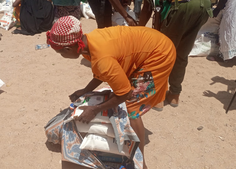 Agnes Ndeti, a resident of Modogashe in Lagdera,carries her share of relief food .