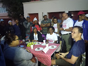 Cape Town Mayco Member Brett Herron discussing emergency housing with picketers outside his home in Newlands early on Tuesday morning. 