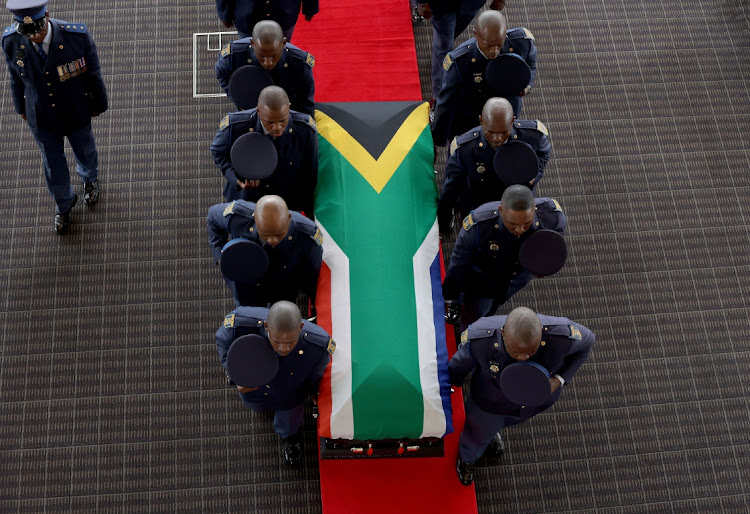 Police officers carry the coffin of playwright Mbongeni Ngema during his special provincial official funeral at the Durban International Convention Centre on Friday.