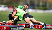 Cameron Wright tackling Robert du Preez of the Cell C Sharks during a training session at Jonsson Kings Park Stadium in Durban.  