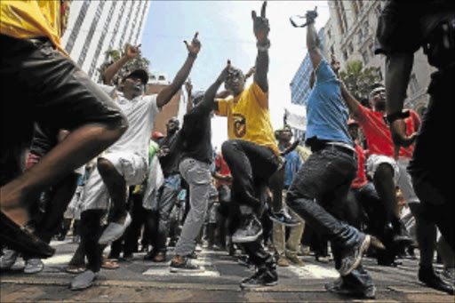 FED UP: Metro police officers toyi-toyi in Durban city centre in February demanding that eThekwini municipality metro police head Eugene Nzama be fired. Photo: THULI DLAMINI