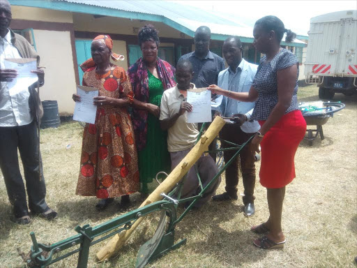 Persons living with disability receive an ox plough /LAMECK BARAZA