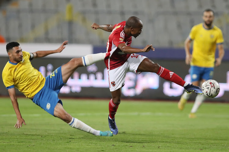 Percy Tau of Al Ahly challenges Mohamed Hesham of Ismaily during the Egypt Nile League on Sunday