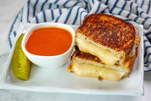 Cheese dripping from a Grilled Cheese With A Twist cut in half.