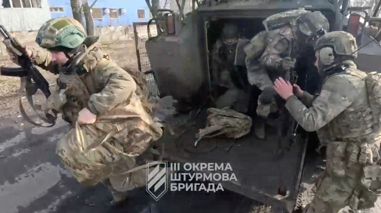 Ukrainian soldiers get out of a military vehicle in a location given as Avdiivka, Donetsk Region, Ukraine, in this screen grab taken from a video released February 17 2024. Picture: 3RD ASSAULT BRIGADE/REUTERS