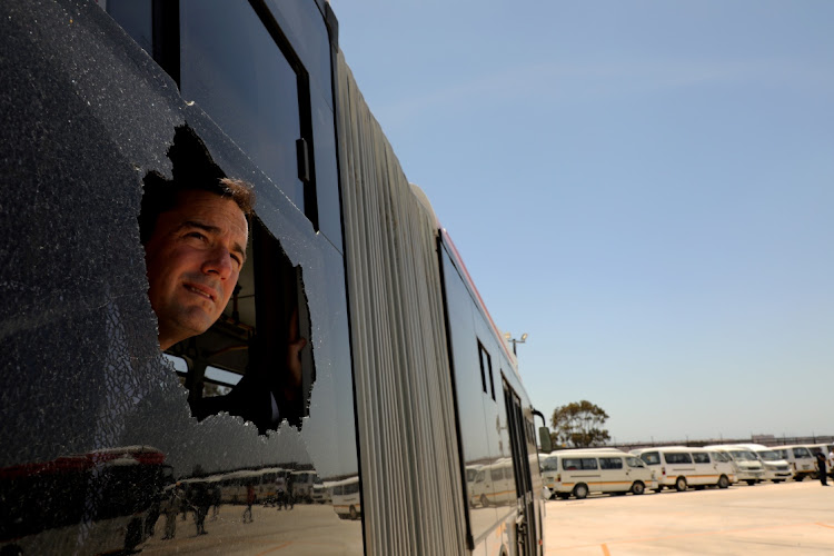 BROKEN CITY: DA interim leader John Steenhuisen visits the IPTS bus depot in Bethelsdorp. He peers through a broken window of a bus damaged on November 5 in the northern areas