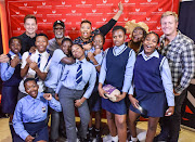 This is what dreams are made of: Anele Mdoda, John Kani and Connie Chiume with underprivileged children at a screening of Black Panther.