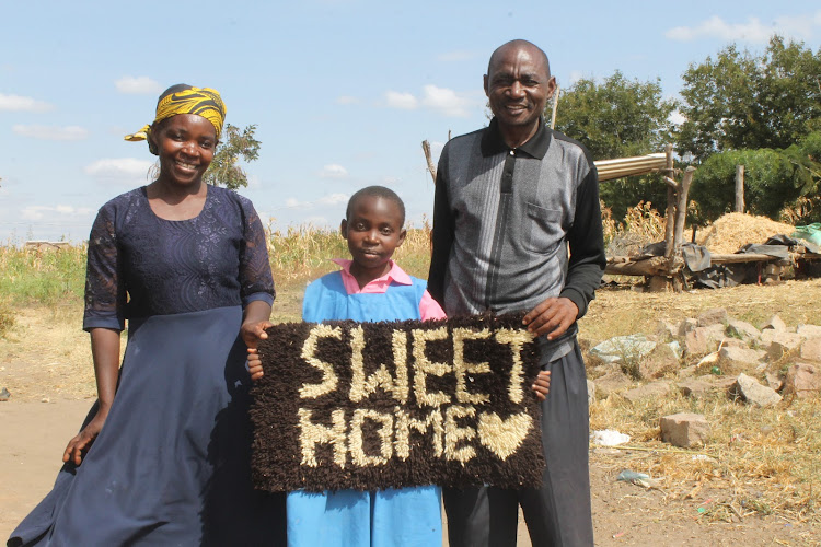 Abigael Mumo with her mother Rose and father John Kyalo at their home in Kaluluini village in Matuu, Machakos county, on Monday, July 19.