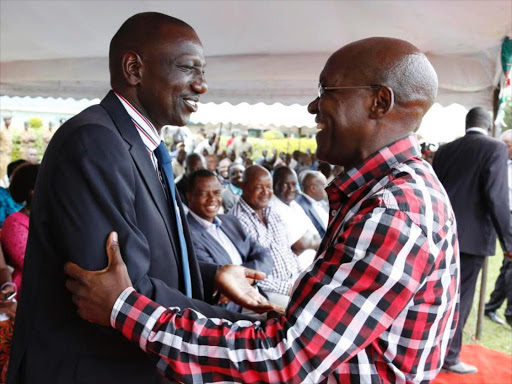 Deputy President William Ruto is embraced by former Kakamega senator Bonny Khalwale during a fundraising in aid of table banking for women and youth groups in Ikolomani and Launch of Idakho sacco at Makhokho secondary school ground on Sunday.pic\Charles Kimani\DPPS