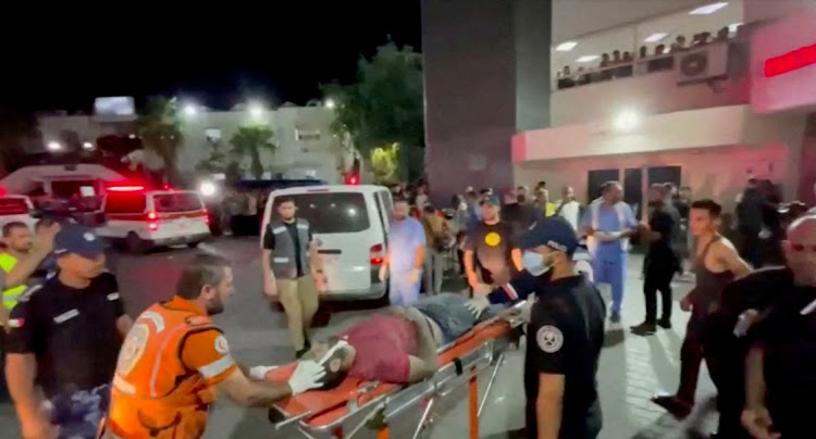 An injured person is taken into a hospital after hundreds of Palestinians were killed in a blast at Al-Ahli hospital in Gaza that Israeli and Palestinian officials blamed on each other, in Gaza City, Gaza Strip, in this screen grab obtained from video, October 17, 2023.