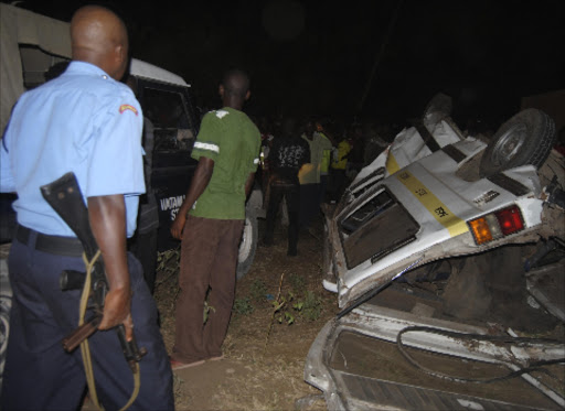 A Police officer keeps order at the accident scene that led to the death of six people at Kwaabudu area along the Malindi Mombasa highway. Photo Alphonce Gari