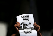 A member of Sri Lankan web journalist association holds a placard during a protest condemning the murder of slain journalist Jamal Khashoggi in front of the Saudi Embassy in Colombo, Sri Lanka, on October 25 2018.