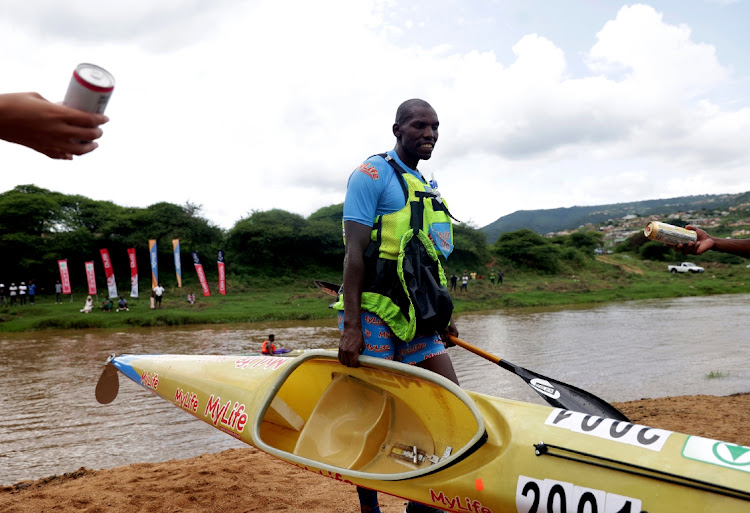 Thulani Mbanjwa finishes on the first day of the Dusi Canoe Marathon at KwaXimba.