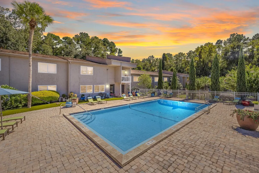 Topaz Grove Swimming pool with surrounding stone patio and lounge furniture