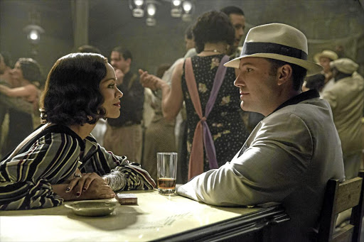 Ben Affleck, right, stars alongside Zoe Saldana in 'Live By Night', a new film about a charismatic gangster which is based on the 2012 novel of the same name by Dennis Lehane.