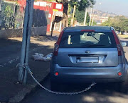 A Ford Figo was chained to a street light outside a block of flats in Glenwood, Durban.