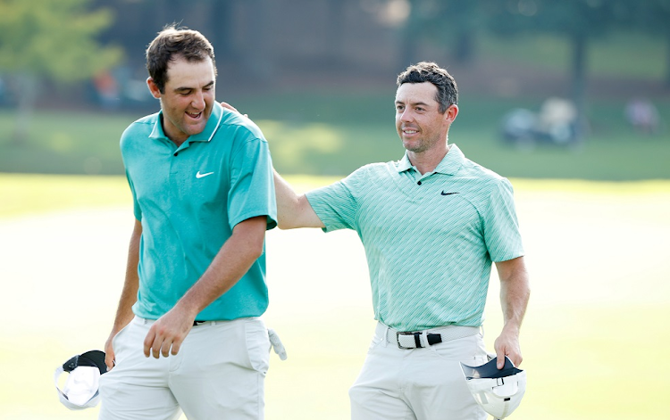 Scottie Scheffler of the US congratulates Rory McIlroy of Northern Ireland on the 18th green after McIlroy won during the final round of the Tour Championship at East Lake Golf Club in Atlanta, Georgia on August 28 2022.