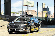 LOOK MA, NO HANDS: A passenger rides in a pilot model of an Uber self-driving car in Pittsburgh, Pennsylvania. Yesterday Uber launched the groundbreaking driverless car service, stealing ahead of Detroit car giants and Silicon Valley rivals