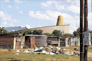 close to home:
       Shacks have been built in the area behind the 
      
      Northern Cape provincial legislature  
      
      
      
      PHOTO: DOUGLAS MTHUKWANE