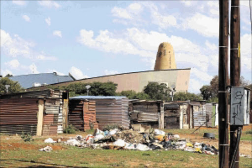 close to home: Shacks have been built in the area behind the Northern Cape provincial legislature PHOTO: DOUGLAS MTHUKWANE