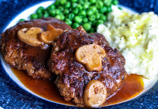 Easy and tasty Salisbury steak with gravy on a plate.