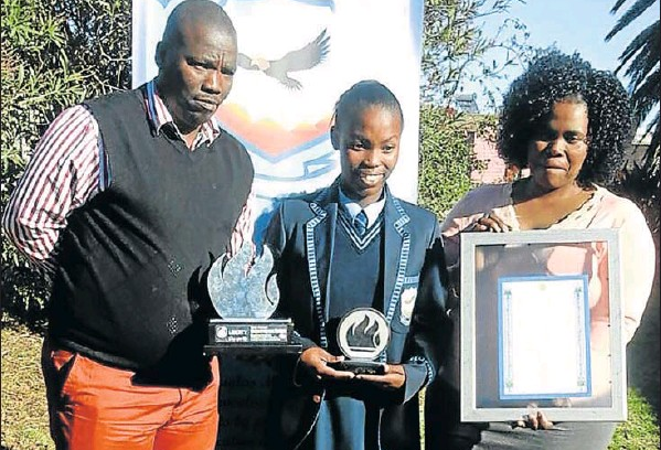 Andisiwe Sango with parents Andile and Nolukhanyo, after she was inaugurated as junior commissioner this week.