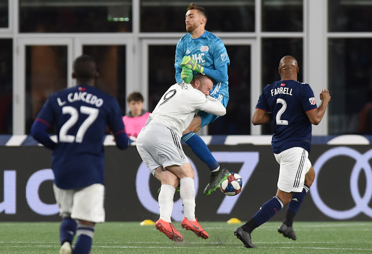 D.C. United forward Wayne Rooney collides with New England Revolution goalkeeper Matt Turner during a recent match