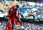 Manchester City's Erling Haaland (right) in action with Liverpool's Wataru Endo.