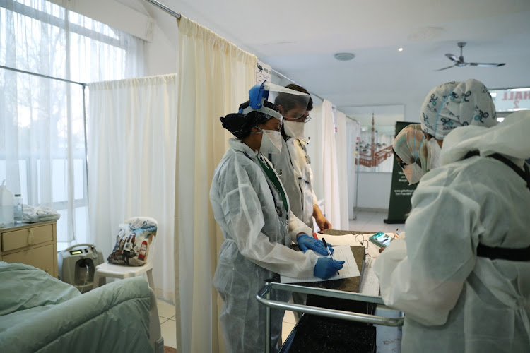 Healthcare workers assist patients being treated at a makeshift hospital run by charity organisation The Gift of the Givers, Johannesburg, July 10 2021.