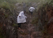 UP and Down: Members of Ekuphakameni Nazareth Baptist Church walking up and down during a holy pilgrimage at Nhlangakazi mountain in Ndwendwe. Photo: SANDILE NDLOVU