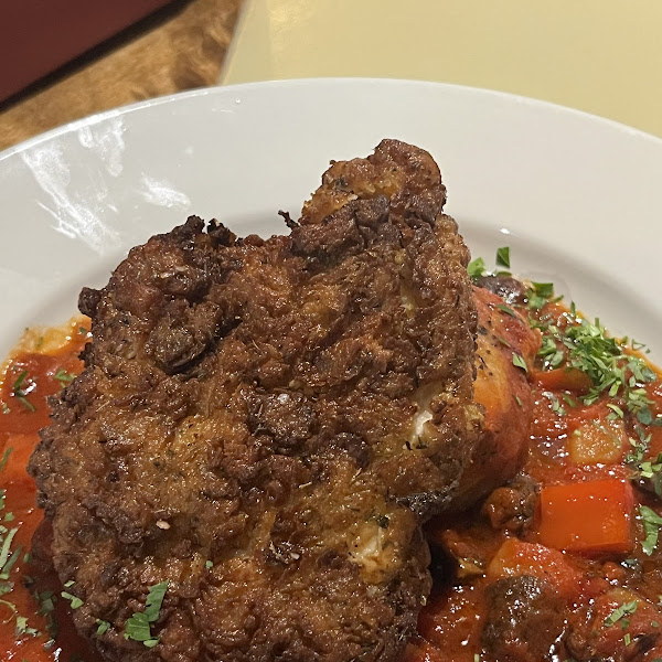 The flagship Chicken Cacciatore with a piece of fried chicken on top. Chicken has a quinoa batter and comes from the gluten free fryer- this dish is a 100% gluten free.