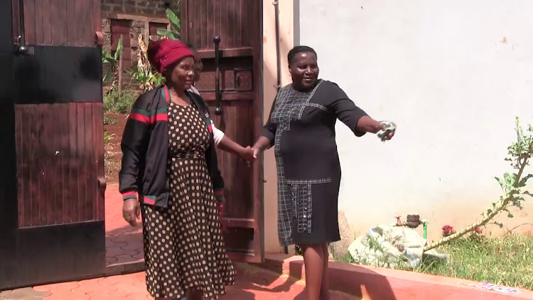 Eunice Ndung'u (right) with a Kandara resident at her home on Mashujaa Day.