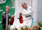 Lewis Hamilton celebrates on the podium after the Chinese Grand Prix.