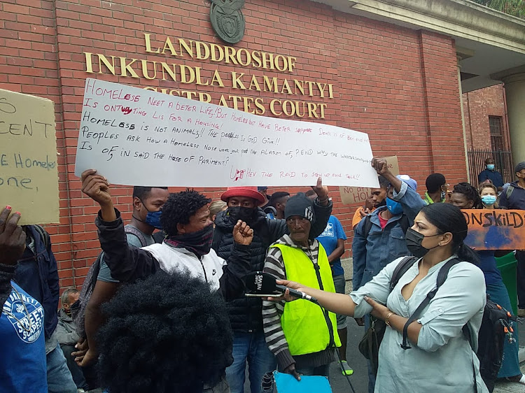 Demonstrators gather outside Cape Town magistrates court on January 11 2022 in support of parliament arson accused Zandile Mafe.