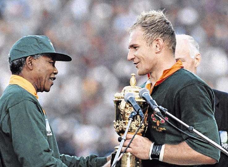 Nelson Mandela congratulates Springbok captain Francois Pienaar after the team beat the All Blacks to win the 1995 rugby World Cup. File photo.