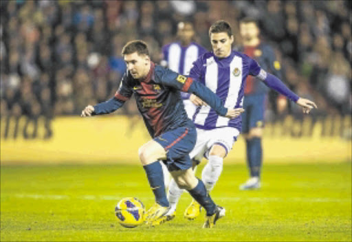 GOLDEN BOY: Lionel Messi of Barcelona fights for the ball during the La Liga game between Real Valladolid and FC Barcelona. Photo: Getty Images